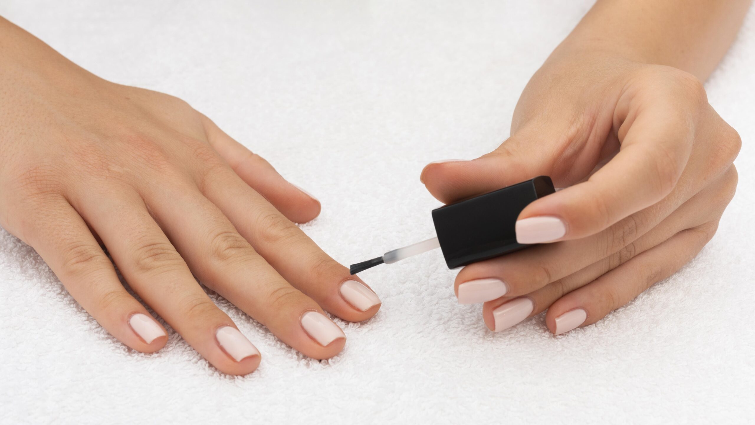 woman-applying-nail-polish