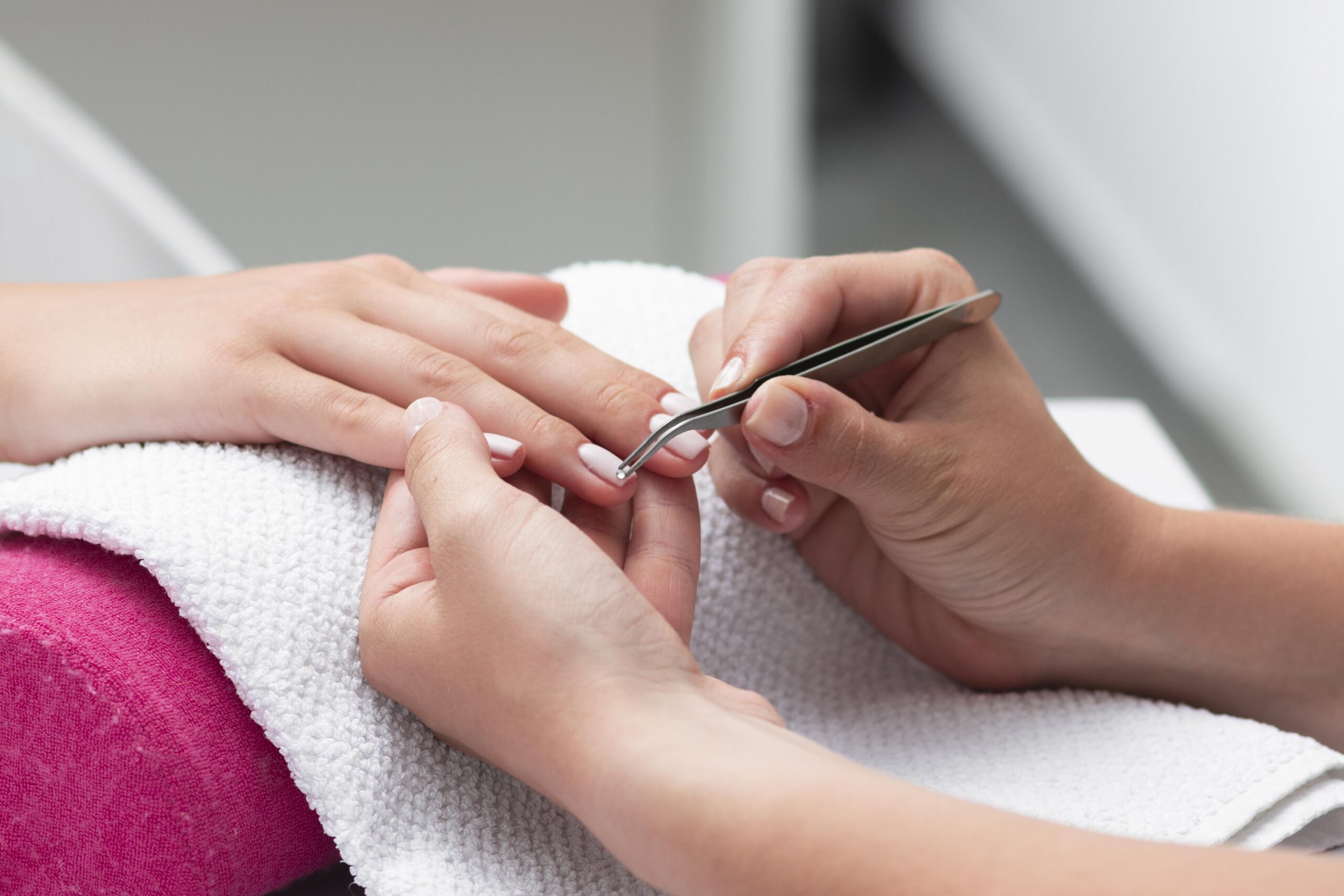 woman-doing-manicure-client-close-up